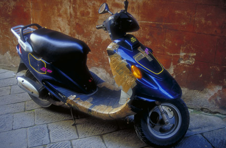 Scooter held together with packing tape, somewhere in Italy.