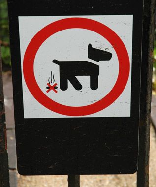 Common sign around London. We assume it means "dogs shall not deposit burning cigars."