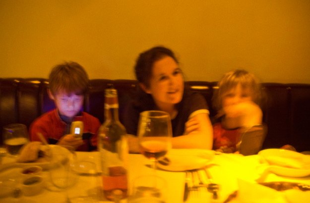 My cousin and her kids having dinner with us. Malcolm just happened to be looking at his mom's cell phone, but it makes it a great "statement" shot.