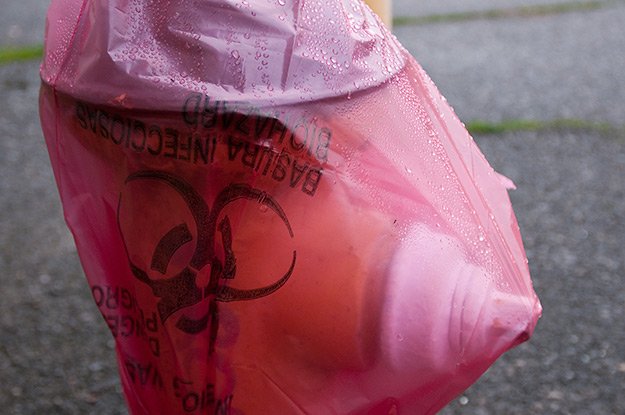 Fire hydrant covered with a hazardous waste bag...?